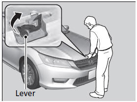 3. Push up the hood latch lever in the center