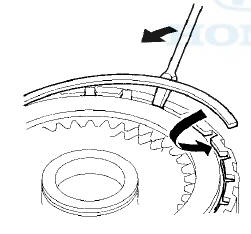 9. Set a dial indicator (A) on the clutch end-plate (B).