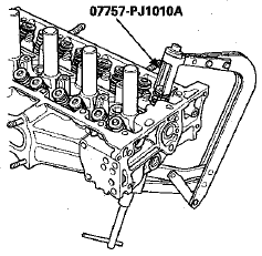 7. Remove the valve spring compressor and the valve