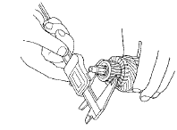 6. Measure the commutator (A) runout.