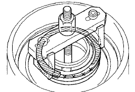 14. Compress the return spring until the snap ring can be