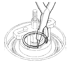 9. Remove the clutch spring compressor,