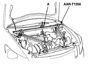 15. Remove the engine mount bolt (A) from the rear