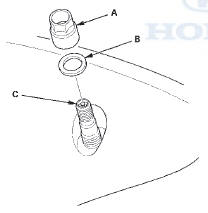 7. Remove and discard the valve stem grommet (A)