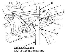 17. Insert the subframe alignment pin through the