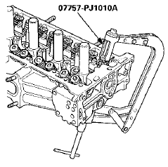 5. Remove the valve spring compressor and the valve