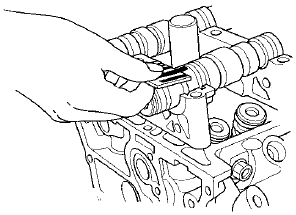 12. Check the total runout with the camshaft supported