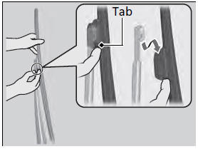 2. Press and hold the tab, then slide the blade